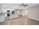Open-concept living room flows into a modern kitchen with stainless steel appliances and a center island at 2660 Orangewood Ct, Palm Harbor, FL 34684