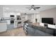 Open-concept living room flows into a modern kitchen with stainless steel appliances and a center island at 2660 Orangewood Ct, Palm Harbor, FL 34684