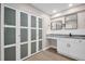 Spacious bathroom with dual sinks, framed mirrors and frosted glass closet at 2660 Orangewood Ct, Palm Harbor, FL 34684