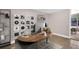 Stylish office with a modern desk setup, unique shelving, and an open layout with convenient access to the lanai at 2660 Orangewood Ct, Palm Harbor, FL 34684