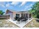 The back patio features outdoor seating, BBQ and a screened in porch at 2660 Orangewood Ct, Palm Harbor, FL 34684