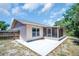 Back patio with a view of the yard, wooden fence and a screened in porch at 2660 Orangewood Ct, Palm Harbor, FL 34684