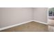 Minimalist room with neutral walls, tiled flooring, and a view to an adjacent room or porch, offering a clean and adaptable space at 2660 Orangewood Ct, Palm Harbor, FL 34684