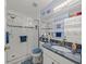 Bright bathroom with blue accents, a glass shower, and modern fixtures at 3340 Oleander Dr, Hernando Beach, FL 34607