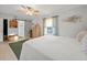 Bright bedroom featuring natural light, ceiling fan, wood floors, closet, and ensuite bathroom at 3340 Oleander Dr, Hernando Beach, FL 34607