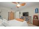 Comfortable bedroom with a ceiling fan, a dresser, a bookshelf, and a white bed at 3340 Oleander Dr, Hernando Beach, FL 34607