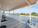 Spacious covered deck with white railings overlooking the serene waterfront at 3340 Oleander Dr, Hernando Beach, FL 34607