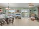 Cozy dining area with water views, modern lighting, and sliding glass doors to the balcony at 3340 Oleander Dr, Hernando Beach, FL 34607