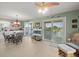 Dining area with water views, a decorative fireplace, and a door to the balcony at 3340 Oleander Dr, Hernando Beach, FL 34607