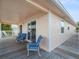 Charming home exterior with a spacious covered deck and stylish outdoor seating, perfect for relaxation at 3340 Oleander Dr, Hernando Beach, FL 34607