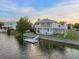Canal front home featuring a private dock, inviting facade, and lush landscaping at 3340 Oleander Dr, Hernando Beach, FL 34607