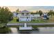 Waterfront property featuring a private dock, elevated deck, and lush landscaping at 3340 Oleander Dr, Hernando Beach, FL 34607