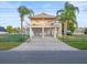 Elevated waterfront home featuring spacious driveway, ample parking, and inviting facade at 3340 Oleander Dr, Hernando Beach, FL 34607