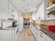 Kitchen featuring marble countertops, modern appliances, and adjacent laundry area at 3340 Oleander Dr, Hernando Beach, FL 34607