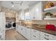 Kitchen area features marble counters, stainless appliances, and laundry machines at 3340 Oleander Dr, Hernando Beach, FL 34607
