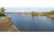 Wide-angle view of a tranquil waterfront landscape with lush greenery and neighboring homes along the shoreline at 3340 Oleander Dr, Hernando Beach, FL 34607