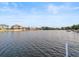 Calm waterfront vista showcasing the serene waters and neighboring homes along the tranquil shoreline at 3340 Oleander Dr, Hernando Beach, FL 34607