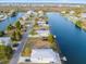 Stunning aerial view of a waterfront lot with a charming house, canal access, and lush greenery at 3340 Oleander, Hernando Beach, FL 34607