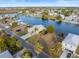 Aerial view of a waterfront lot with a charming house, canal access, and lush greenery at 3340 Oleander, Hernando Beach, FL 34607