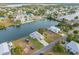 Aerial view of a waterfront property with lush greenery, canal access, and a charming house at 3340 Oleander, Hernando Beach, FL 34607