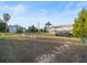 Expansive front yard with lush green grass, agility training equipment, a parked van, and a charming house in the background at 3340 Oleander, Hernando Beach, FL 34607