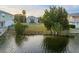 A beautiful view of a waterfront property with lush greenery and serene water reflecting the sky at 3340 Oleander, Hernando Beach, FL 34607