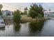 Picturesque waterfront view showcasing lush greenery meeting calm waters under a serene sky at 3340 Oleander, Hernando Beach, FL 34607