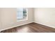 Cozy bedroom with hardwood floors, neutral walls, and a window overlooking a playground at 3410 Thistledown Ln, Land O Lakes, FL 34638