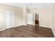 Spacious bedroom with wood-look flooring, a ceiling fan, closet, and access to an ensuite bathroom at 3410 Thistledown Ln, Land O Lakes, FL 34638