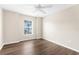 Well-lit bedroom features hardwood floors, a window, neutral walls, and ample space at 3410 Thistledown Ln, Land O Lakes, FL 34638