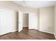 Bright bedroom showcasing hardwood floors, two closets, a ceiling fan, and neutral walls at 3410 Thistledown Ln, Land O Lakes, FL 34638
