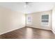 A bright bedroom features a ceiling fan, wood floors and natural light from two windows at 3410 Thistledown Ln, Land O Lakes, FL 34638