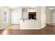 View of breakfast bar with seating and kitchen appliances, closet space, and access to the backyard at 3410 Thistledown Ln, Land O Lakes, FL 34638