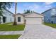 Charming single-story home featuring a paved driveway, two-car garage, and well-maintained lawn at 3410 Thistledown Ln, Land O Lakes, FL 34638