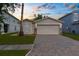 Attractive single-story home boasting a paved driveway, two-car garage, and manicured lawn at 3410 Thistledown Ln, Land O Lakes, FL 34638