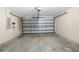 A spacious garage has concrete floors, a grey garage door, and a utility panel at 3410 Thistledown Ln, Land O Lakes, FL 34638