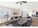 Comfortable living room with large windows, stylish furniture, area rug, and an open view to the kitchen at 3410 Thistledown Ln, Land O Lakes, FL 34638