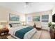 Well-decorated main bedroom features a bed, art, wooden floors, and lots of natural light at 3410 Thistledown Ln, Land O Lakes, FL 34638