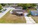 Aerial view showcasing the home's brick facade, front porch, and proximity to the street at 3638 Bigelow Dr, Holiday, FL 34691