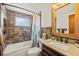 Bathroom featuring tile surround, vanity with granite countertop, and framed mirror at 3638 Bigelow Dr, Holiday, FL 34691