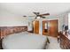 Bedroom with decorative headboard, ceiling fan and closet storage at 3638 Bigelow Dr, Holiday, FL 34691