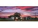 Inviting single-story brick home with a covered porch under a colorful sunset sky at 3638 Bigelow Dr, Holiday, FL 34691