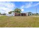 Charming single-story brick home featuring a covered front porch and well-maintained front yard at 3638 Bigelow Dr, Holiday, FL 34691
