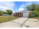 Charming single-story home featuring a brick facade, a well-maintained lawn, and an American flag at 3638 Bigelow Dr, Holiday, FL 34691
