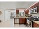 Modern kitchen with stainless steel appliances and granite countertops, with an adjacent dining area at 3638 Bigelow Dr, Holiday, FL 34691