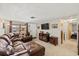 Cozy living room with a comfortable leather sectional, TV, and neutral decor at 3638 Bigelow Dr, Holiday, FL 34691