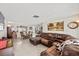 Open-concept living room with a large leather sectional and lots of natural light at 3638 Bigelow Dr, Holiday, FL 34691
