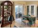 Charming dining area featuring a glass-top table and sliding glass doors to a screened patio at 4047 Eagle Cove West Dr, Palm Harbor, FL 34685