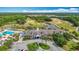 Stunning aerial view of the community clubhouse with golf course and lake view at 4207 Fishermans Lake Dr, Lutz, FL 33558