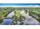 Aerial view of neighborhood entrance with water features and lush landscaping at 4207 Fishermans Lake Dr, Lutz, FL 33558